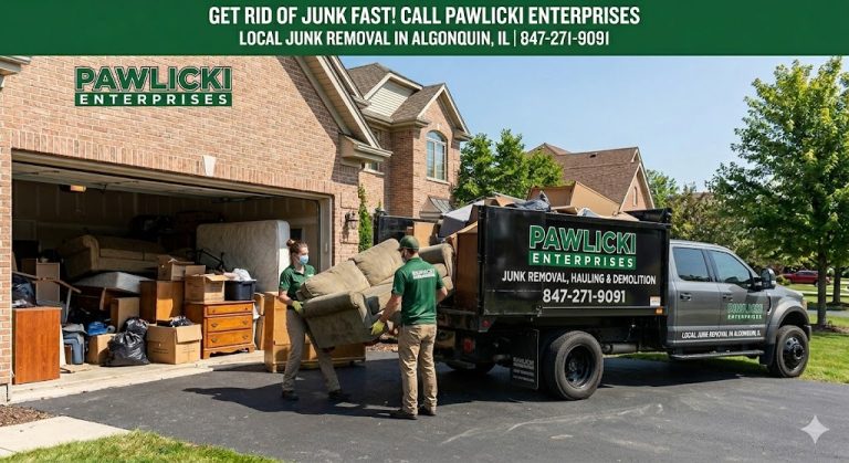 Pawlicki Enterprises professional junk removal crew loading a sofa into a grey truck and black dump trailer during a garage cleanout in Algonquin, IL.